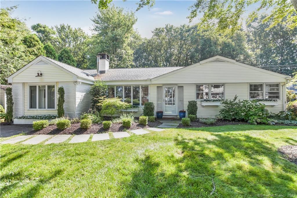 a view of a house with a yard patio and fire pit