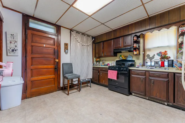 a kitchen with a refrigerator and white cabinets