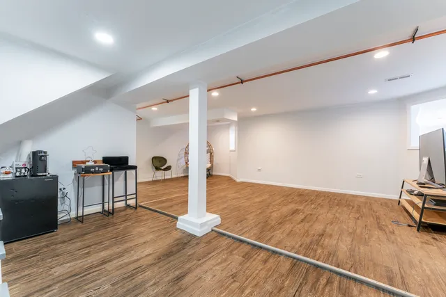 a view of a living room and kitchen with furniture wooden floor and a rug