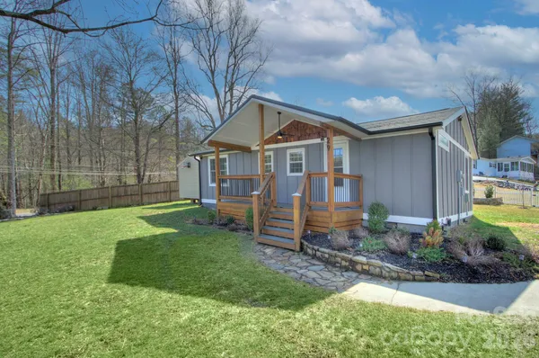 a front view of a house with a yard table and chairs