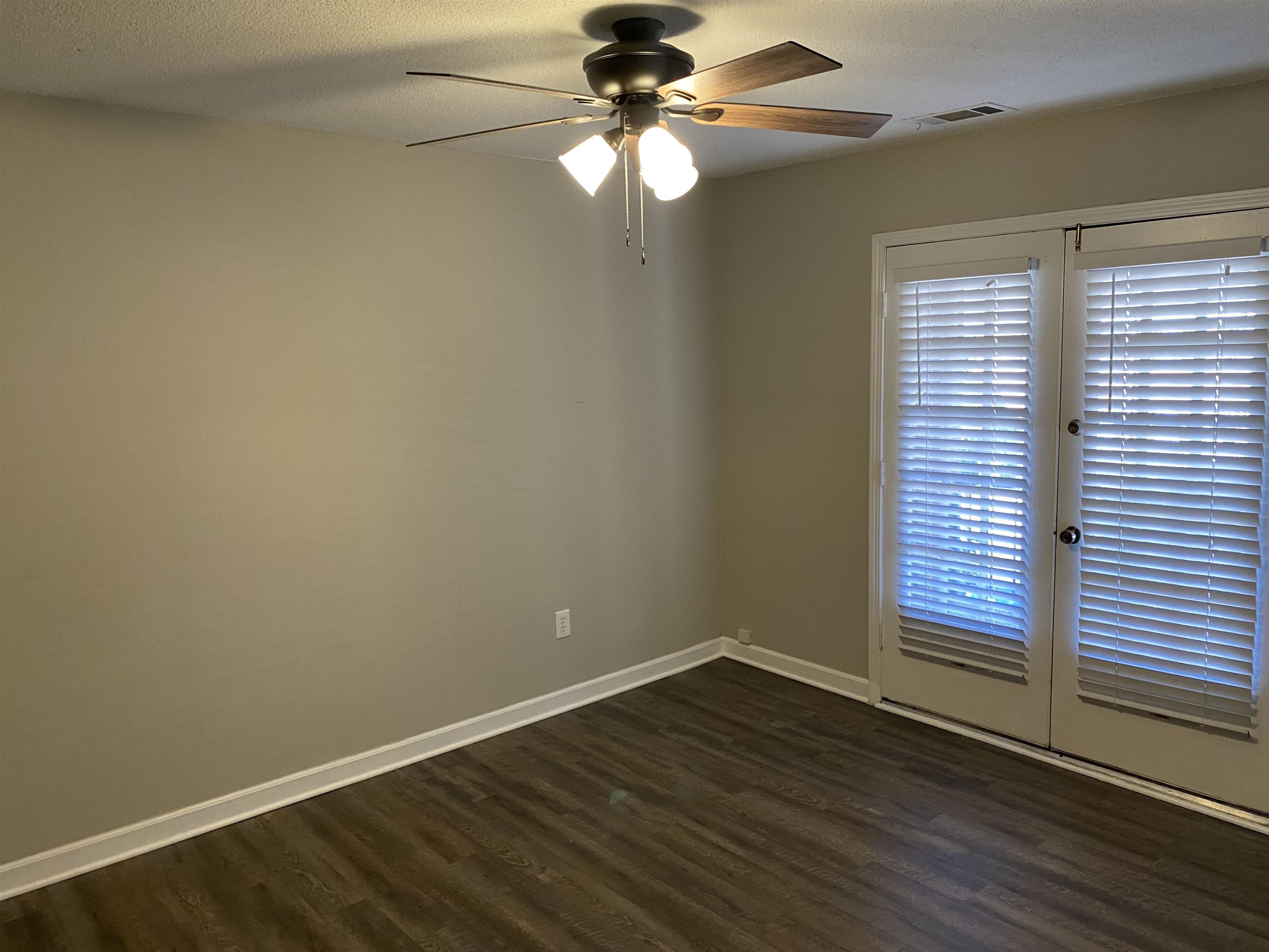 5696 Quince Road, Unit 7 Memphis, TN 38119 - Photo 2 of 15 wooden floor in an empty room with a window