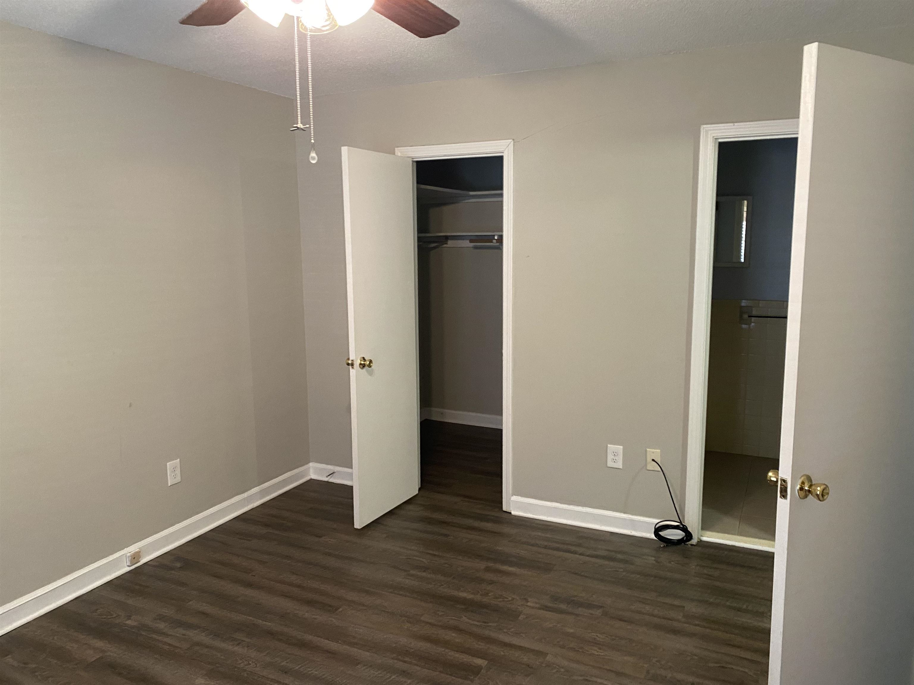 5696 Quince Road, Unit 7 Memphis, TN 38119 - Photo 7 of 15 an empty room with wooden floor and closet