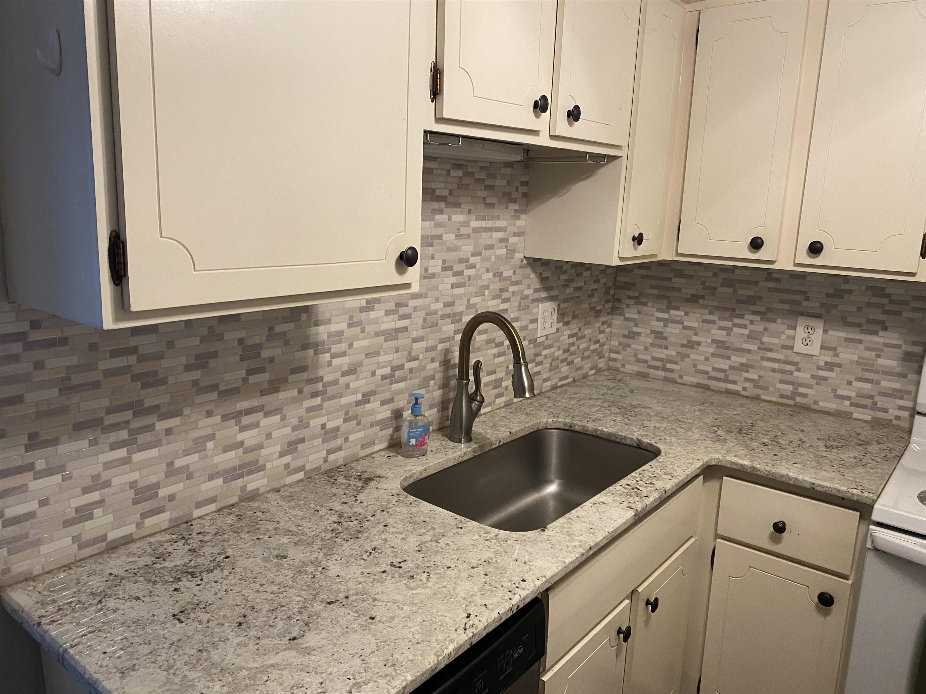 5696 Quince Road, Unit 7 Memphis, TN 38119 - Photo 10 of 15 a kitchen with granite countertop a sink and a stove