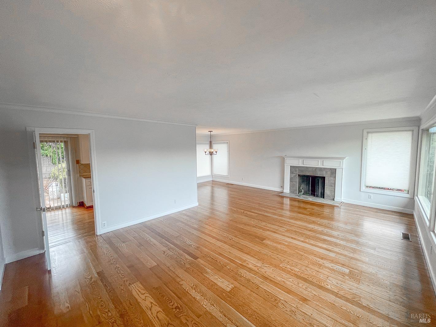 112 Reed Boulevard Mill Valley, CA 94941 - Photo 13 of 39 a view of empty room with wooden floor and fireplace