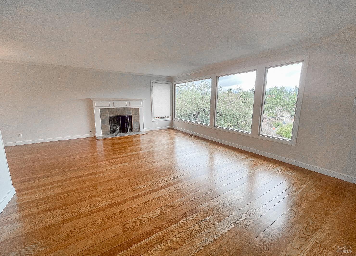 112 Reed Boulevard Mill Valley, CA 94941 - Photo 14 of 39 a view of empty room with wooden floor and fireplace