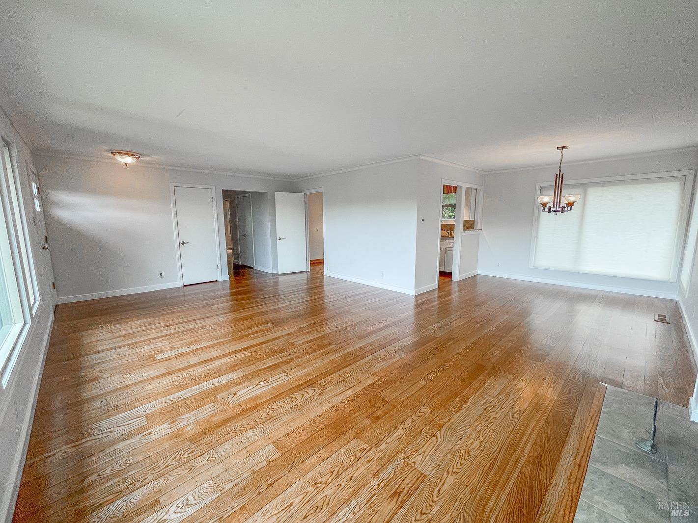 112 Reed Boulevard Mill Valley, CA 94941 - Photo 15 of 39 an empty room with wooden floor and windows