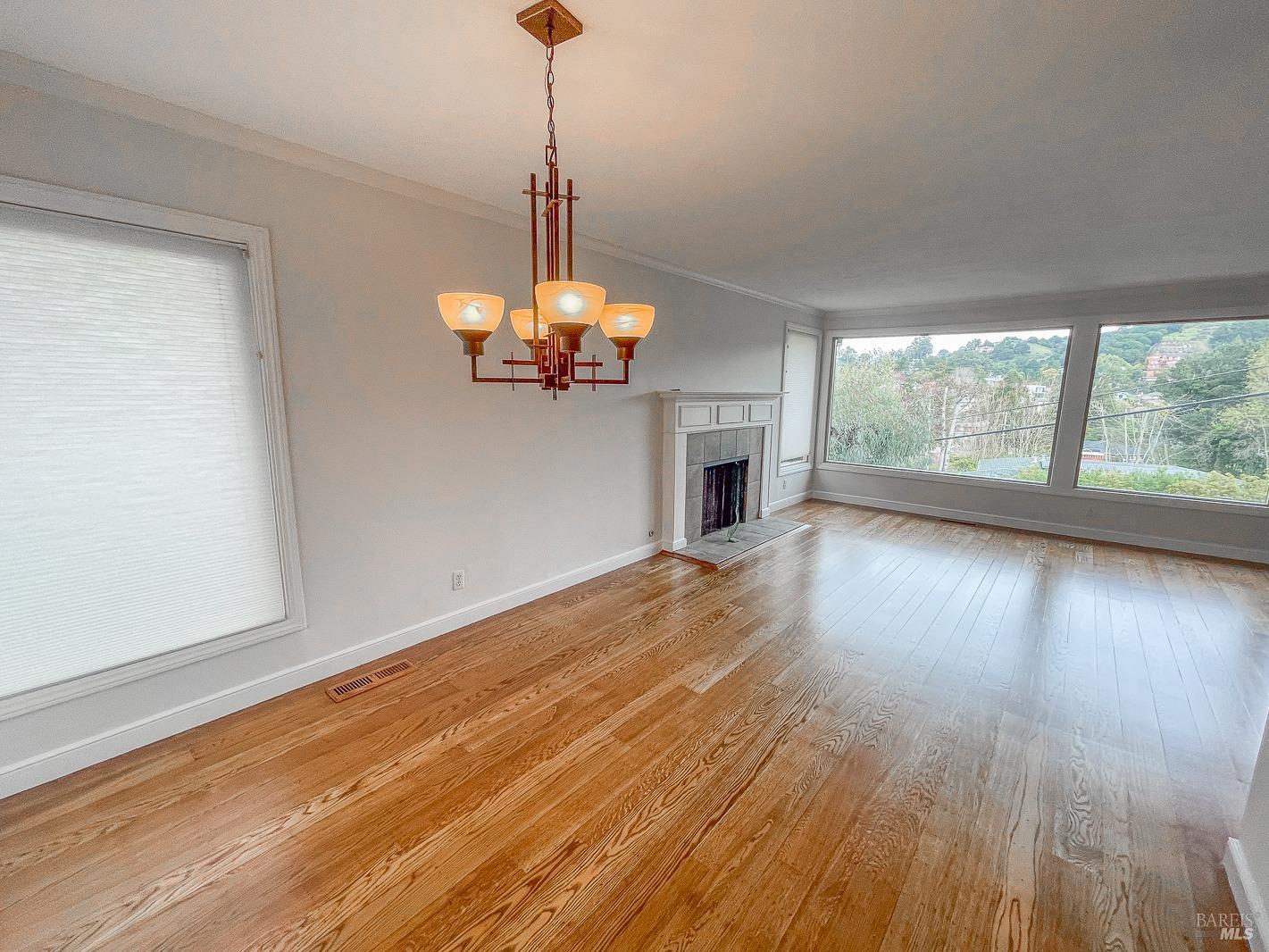 112 Reed Boulevard Mill Valley, CA 94941 - Photo 17 of 39 a view of a livingroom with wooden floor a chandelier