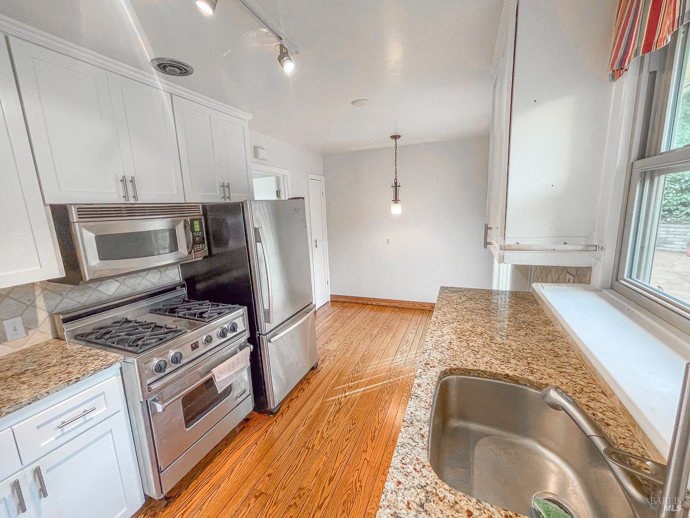 112 Reed Boulevard Mill Valley, CA 94941 - Photo 18 of 39 a kitchen with stainless steel appliances granite countertop a sink stove and refrigerator