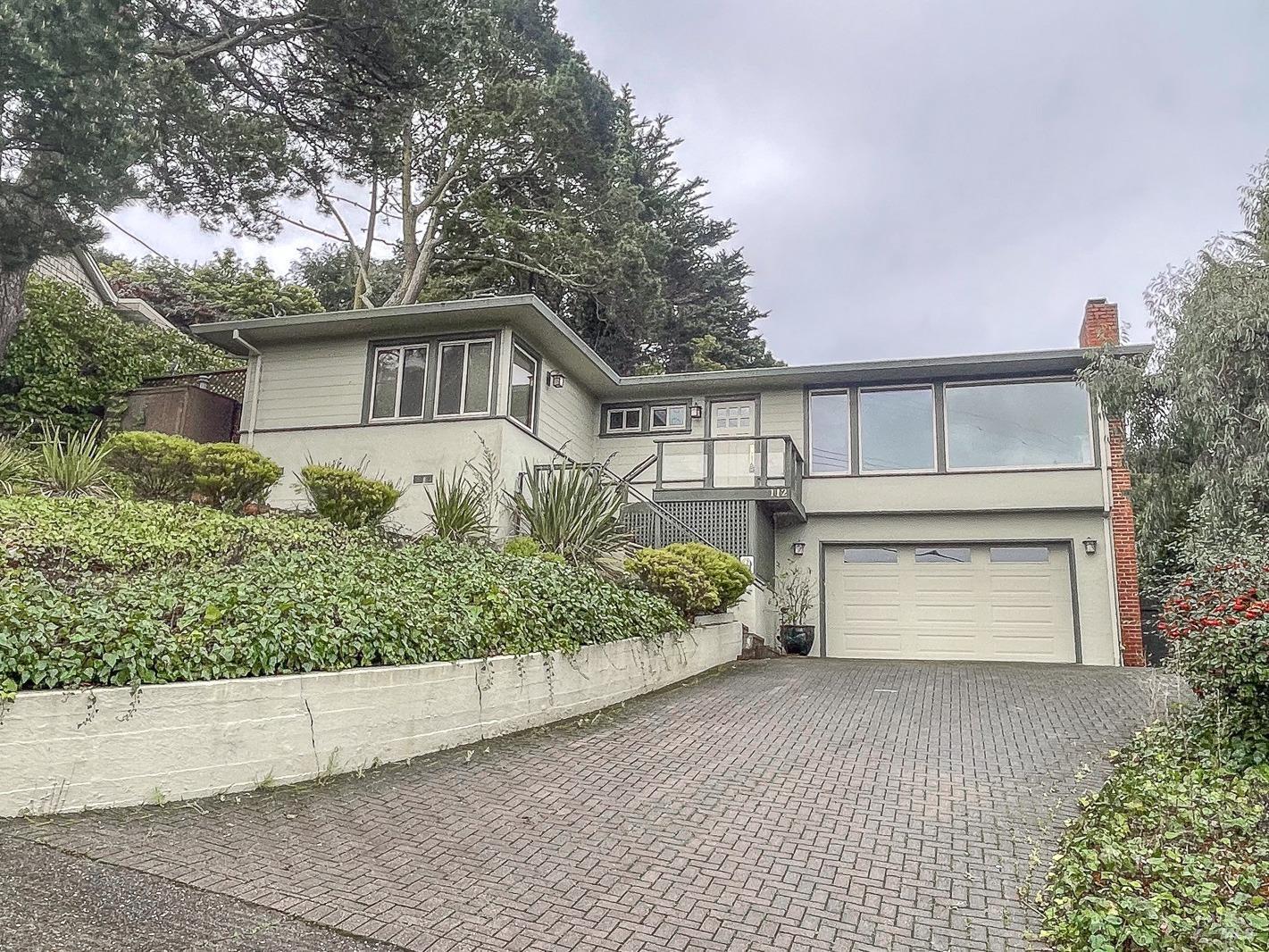 112 Reed Boulevard Mill Valley, CA 94941 - Photo 2 of 39 a front view of a house with a yard and garage