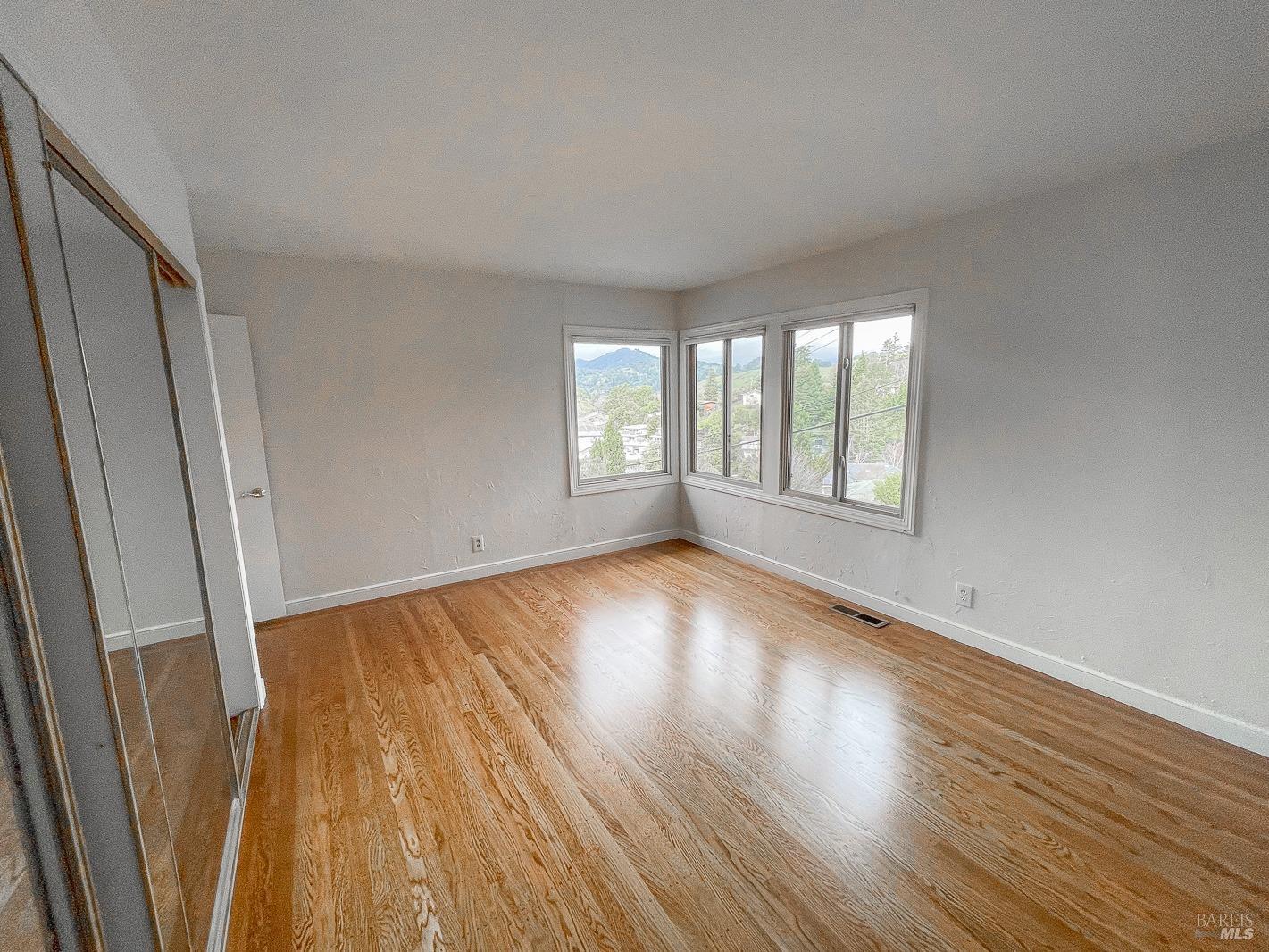 112 Reed Boulevard Mill Valley, CA 94941 - Photo 27 of 39 a view of an empty room with wooden floor and window