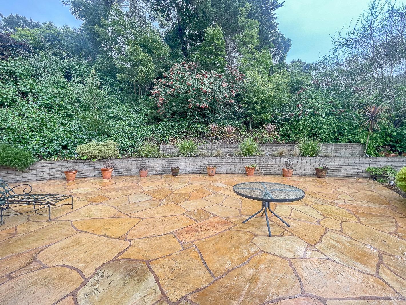 112 Reed Boulevard Mill Valley, CA 94941 - Photo 37 of 39 a backyard of a house with table and chairs