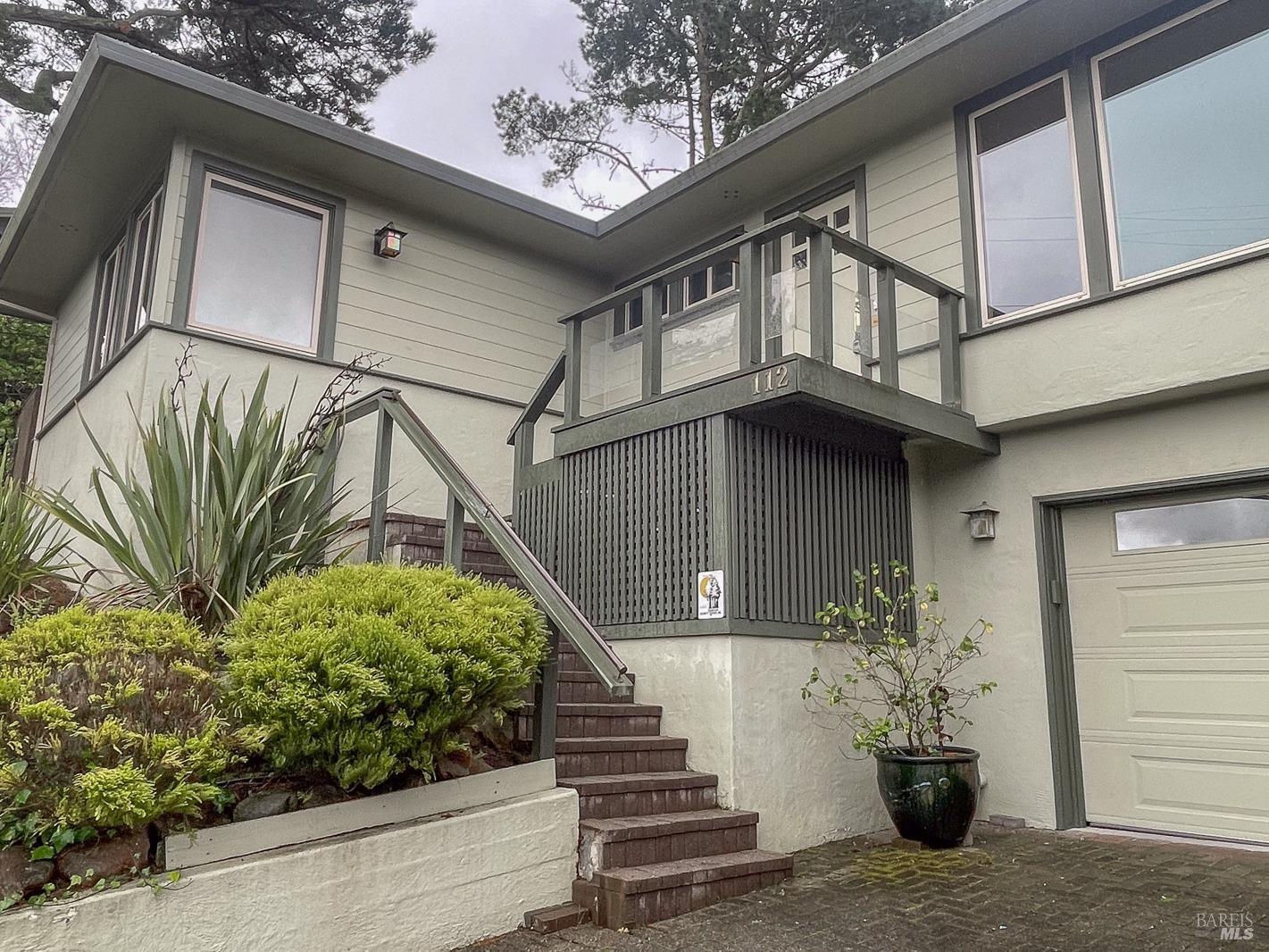 112 Reed Boulevard Mill Valley, CA 94941 - Photo 6 of 39 a view of a house with a flower plants next to a road