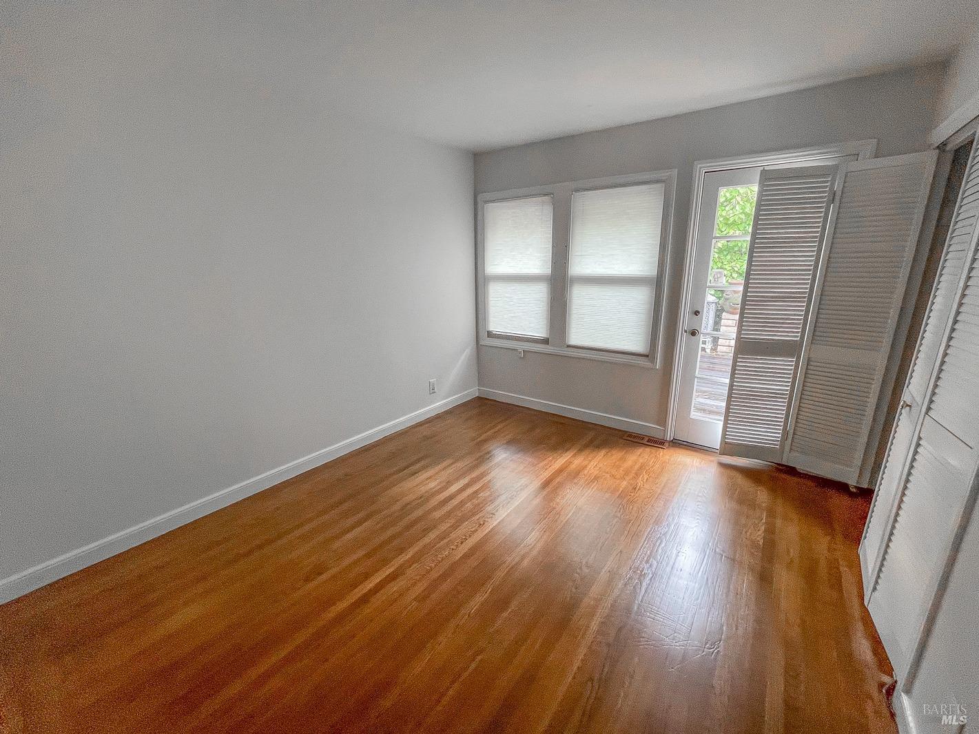 112 Reed Boulevard Mill Valley, CA 94941 - Photo 9 of 39 an empty room with wooden floor and windows