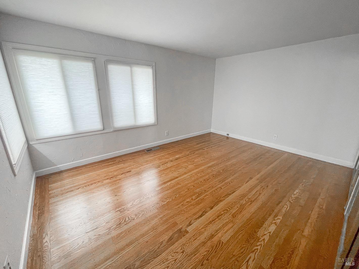 112 Reed Boulevard Mill Valley, CA 94941 - Photo 10 of 39 a view of empty room with wooden floor and fan