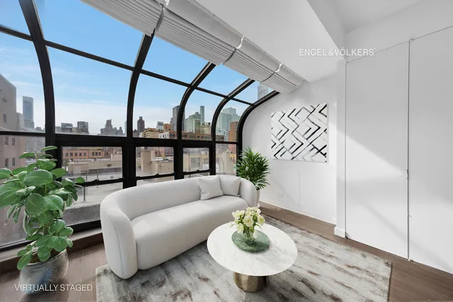 a living room with furniture and a potted plant