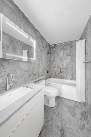 a bathroom with a sink toilet and shower