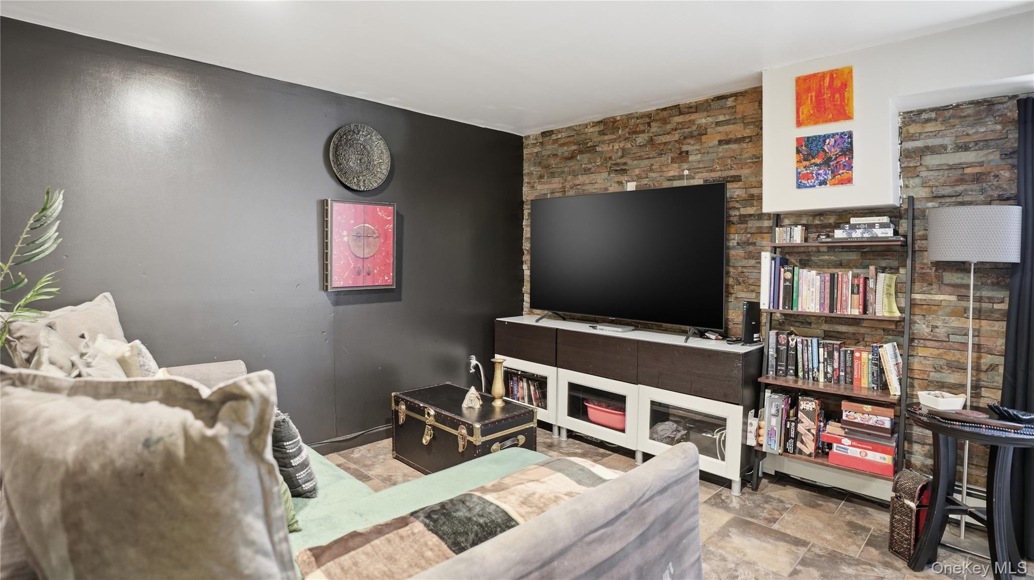 253 Cornelia Street Brooklyn, NY 11221 - Photo 19 of 36 a living room with furniture and a flat screen tv