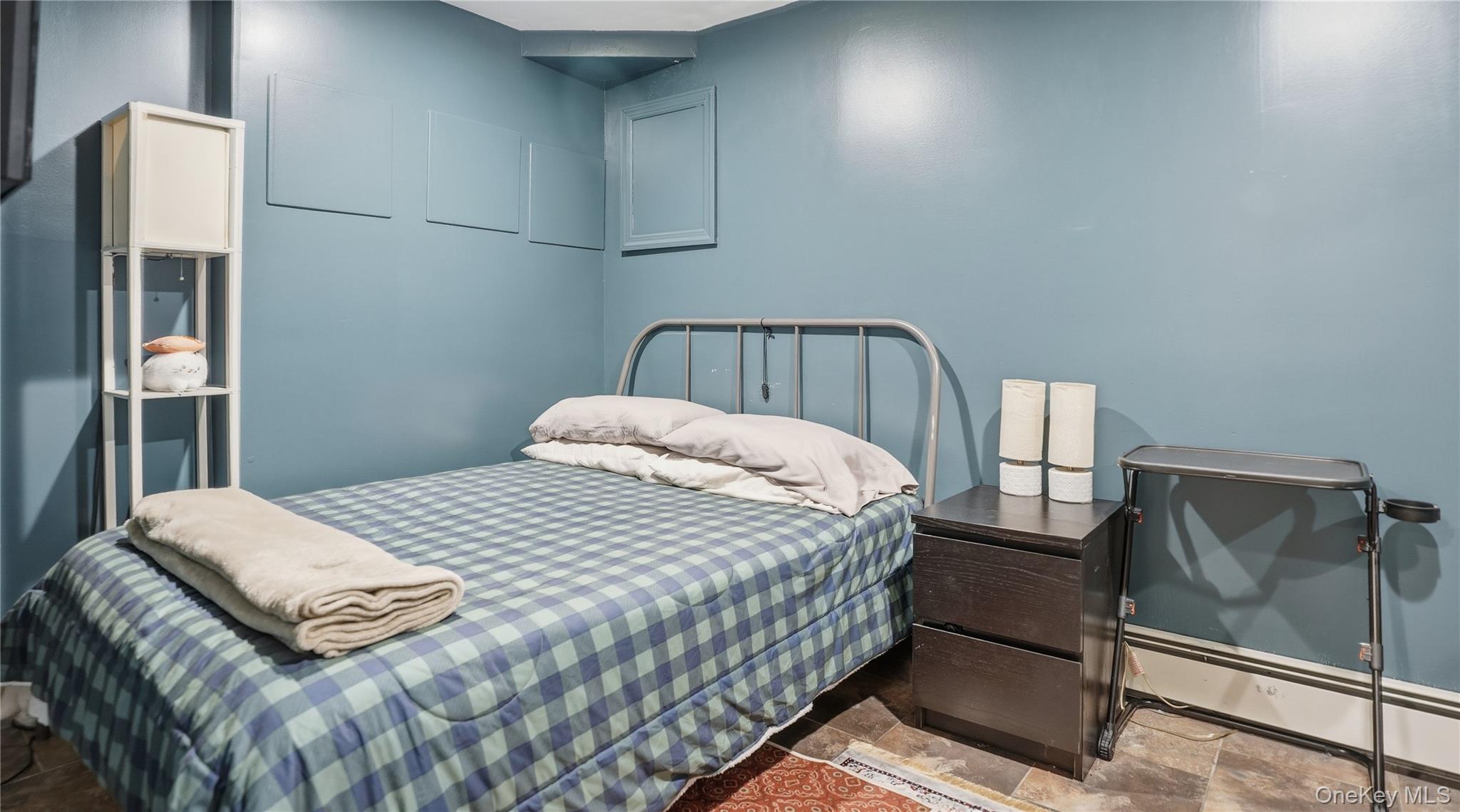 253 Cornelia Street Brooklyn, NY 11221 - Photo 20 of 36 a bedroom with a bed and wooden floor
