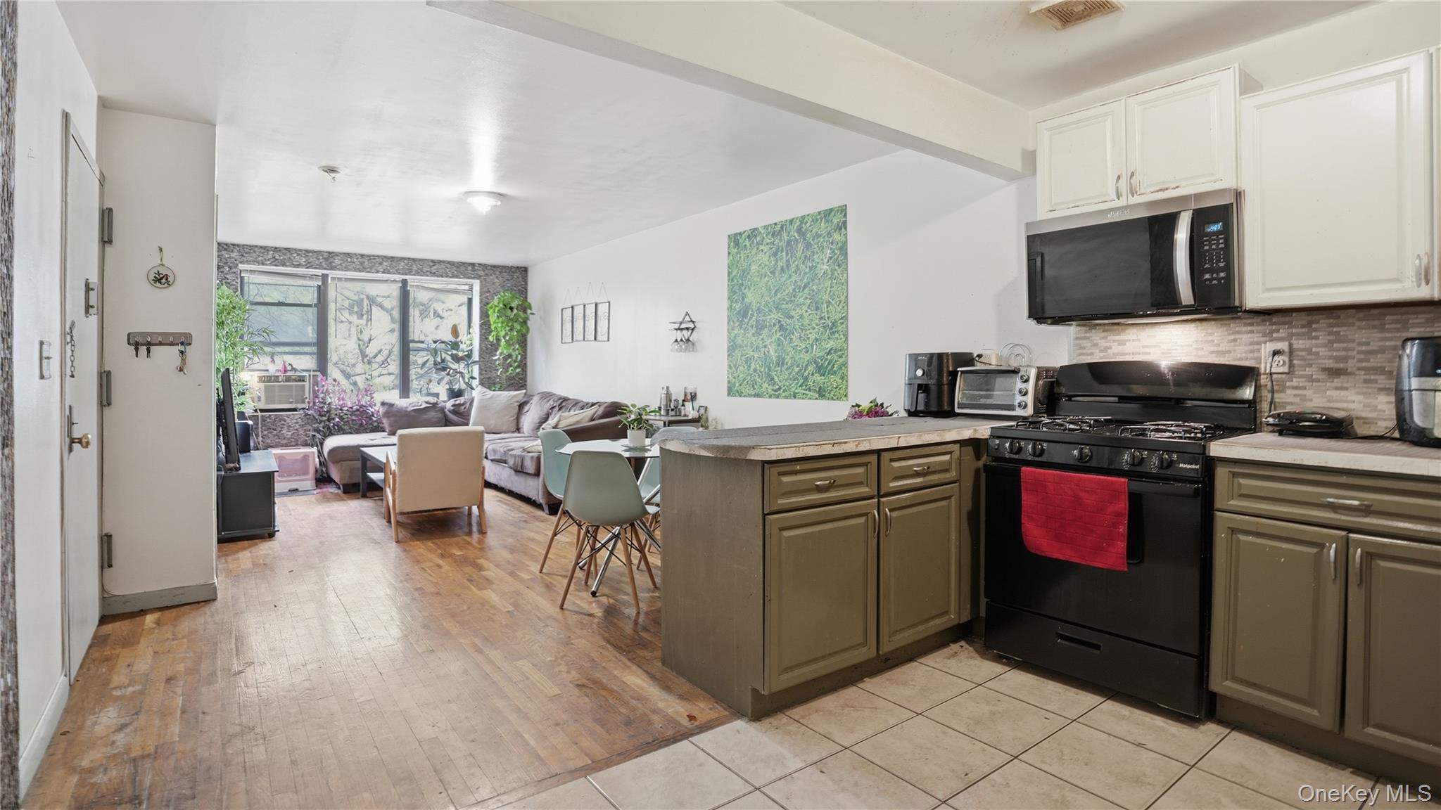 253 Cornelia Street Brooklyn, NY 11221 - Photo 21 of 36 a kitchen with a sink stove and cabinets