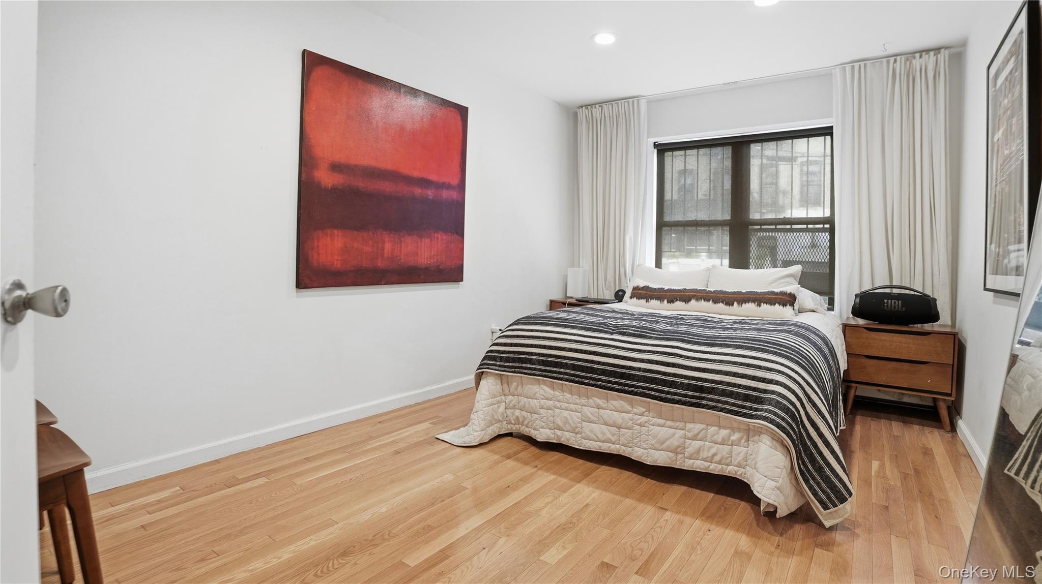 253 Cornelia Street Brooklyn, NY 11221 - Photo 26 of 36 a bedroom with a bed and a large window