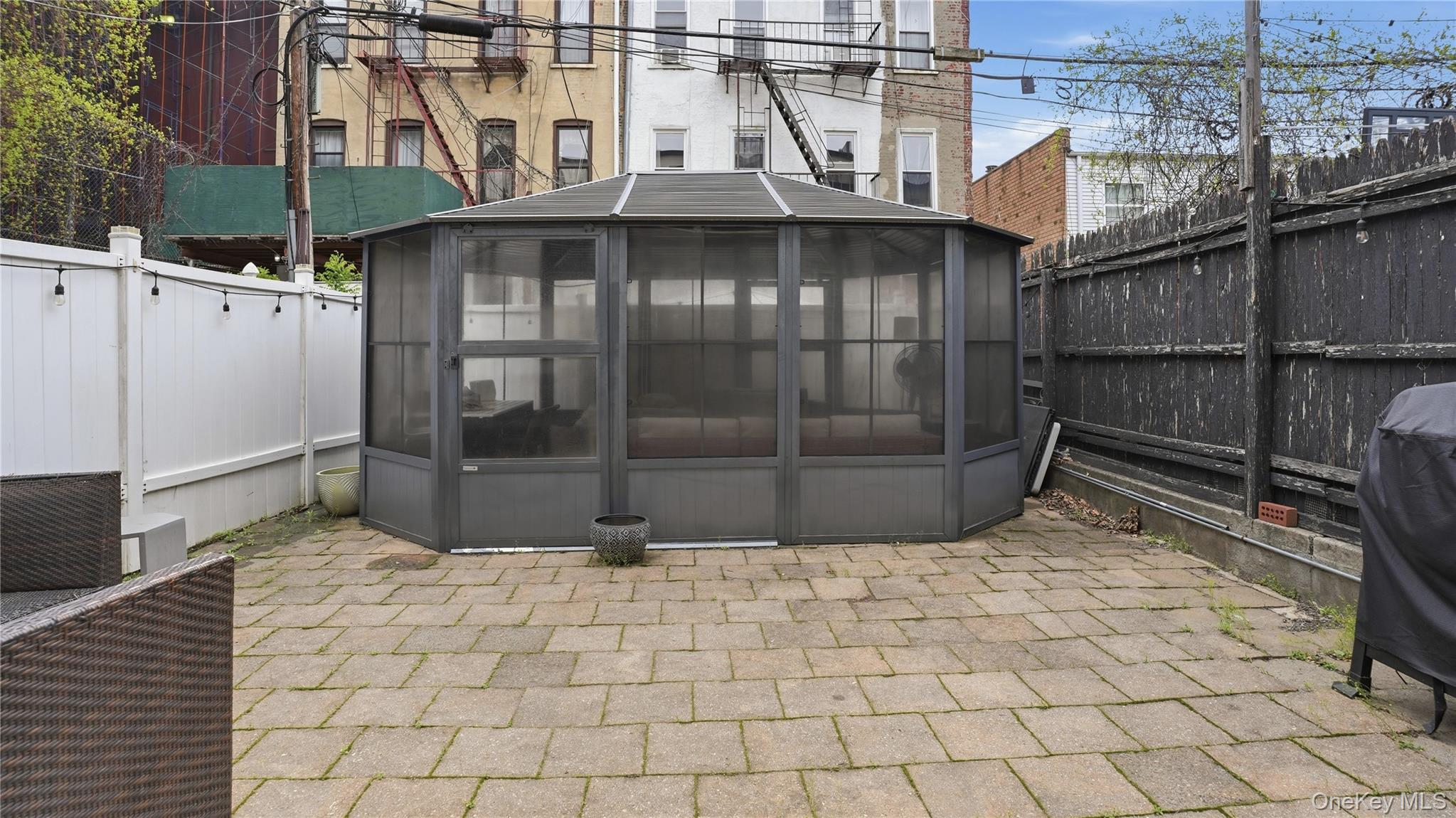 253 Cornelia Street Brooklyn, NY 11221 - Photo 32 of 36 a view of a house with a wooden fence