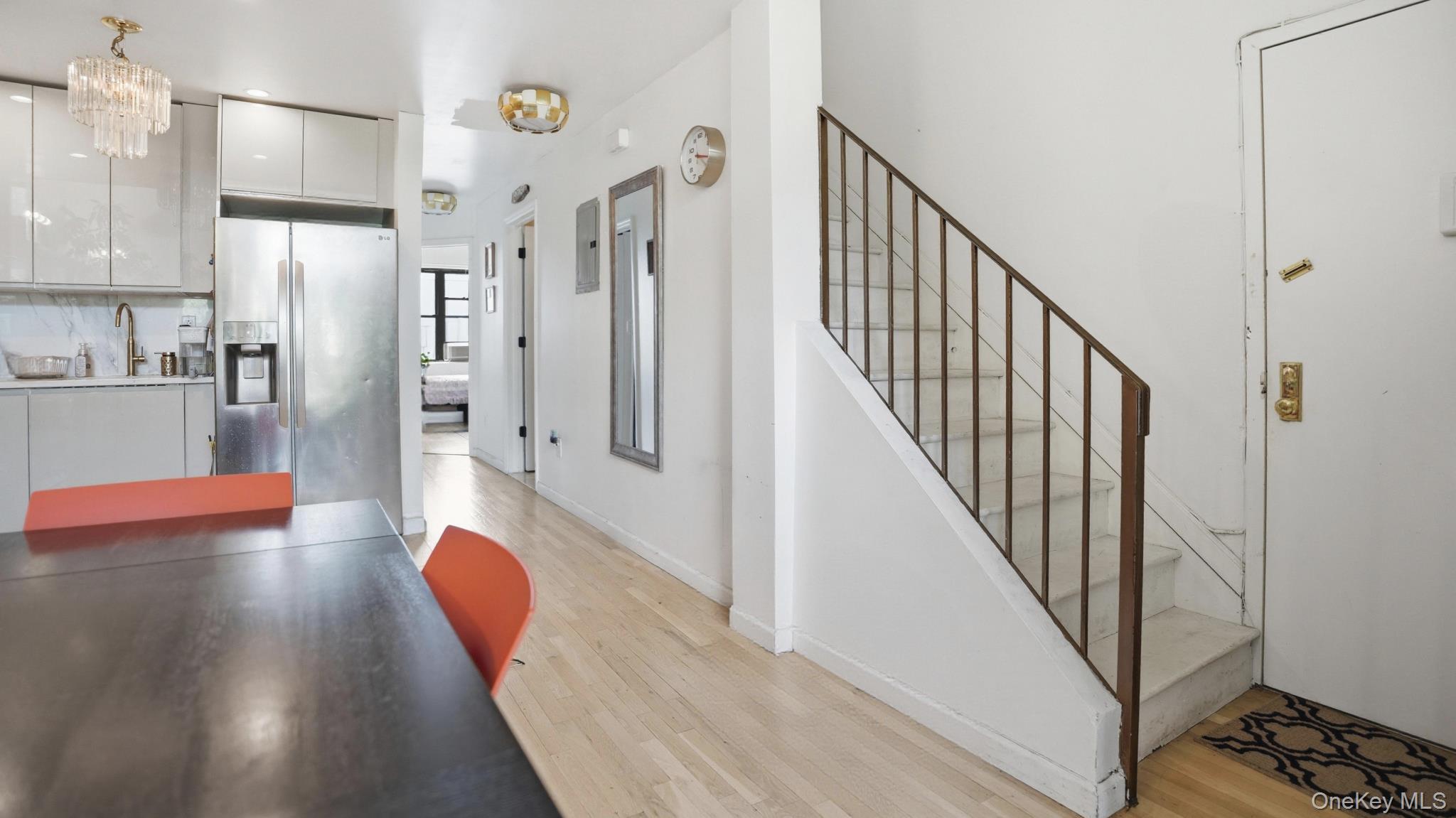 253 Cornelia Street Brooklyn, NY 11221 - Photo 4 of 36 a view of a hallway with stainless steel appliances wooden floor and entryway