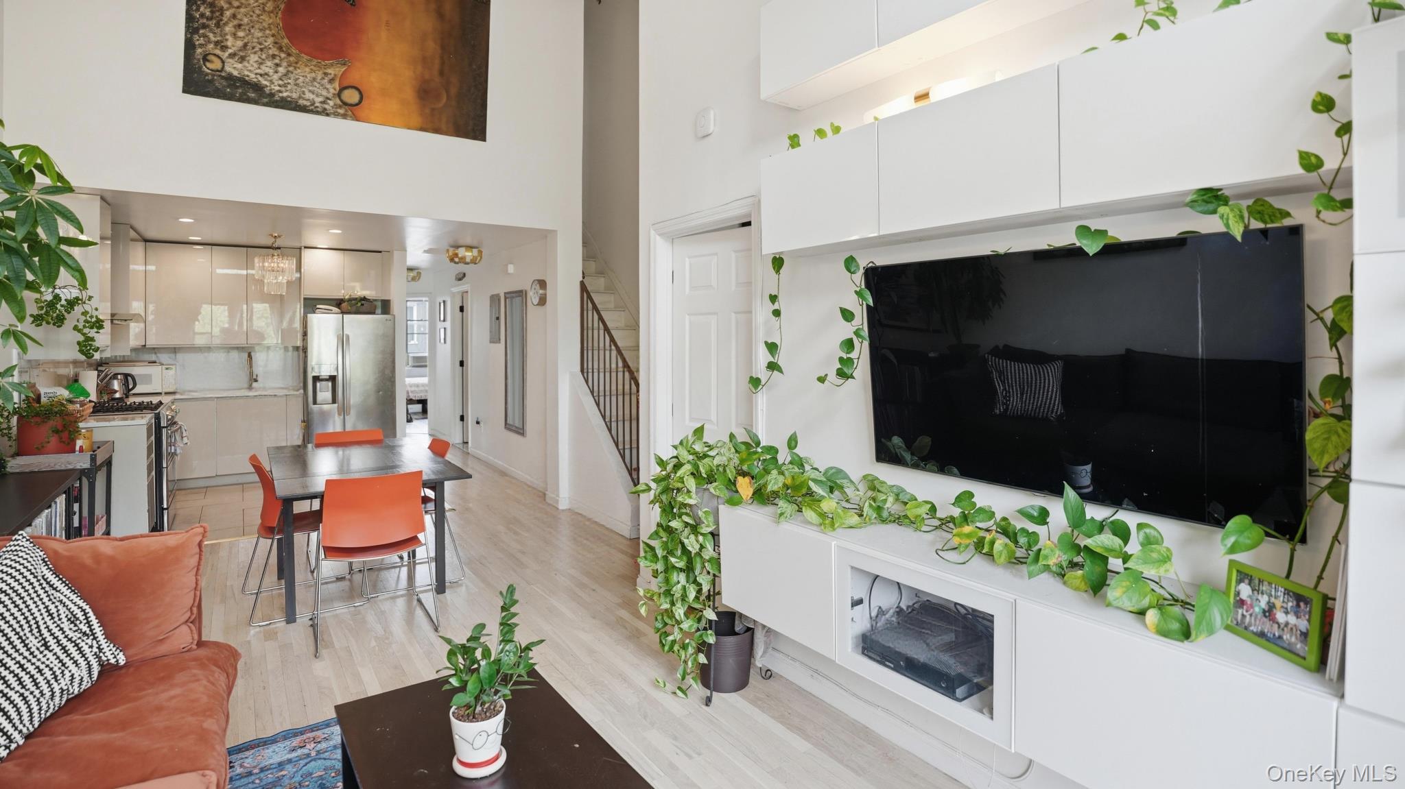 253 Cornelia Street Brooklyn, NY 11221 - Photo 6 of 36 a living room with furniture potted plant and a fireplace