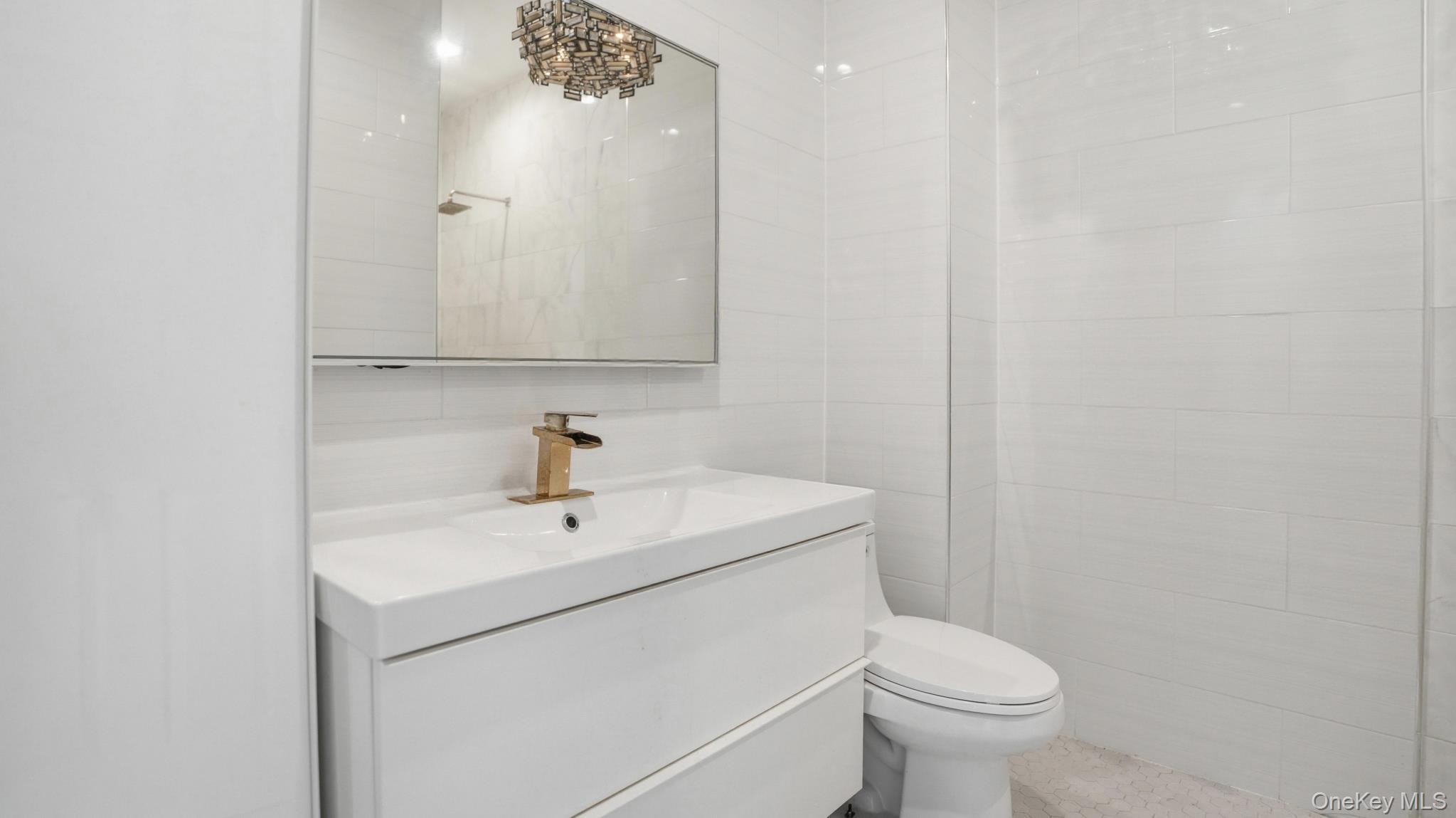 253 Cornelia Street Brooklyn, NY 11221 - Photo 7 of 36 a white toilet sitting next to a bathroom sink