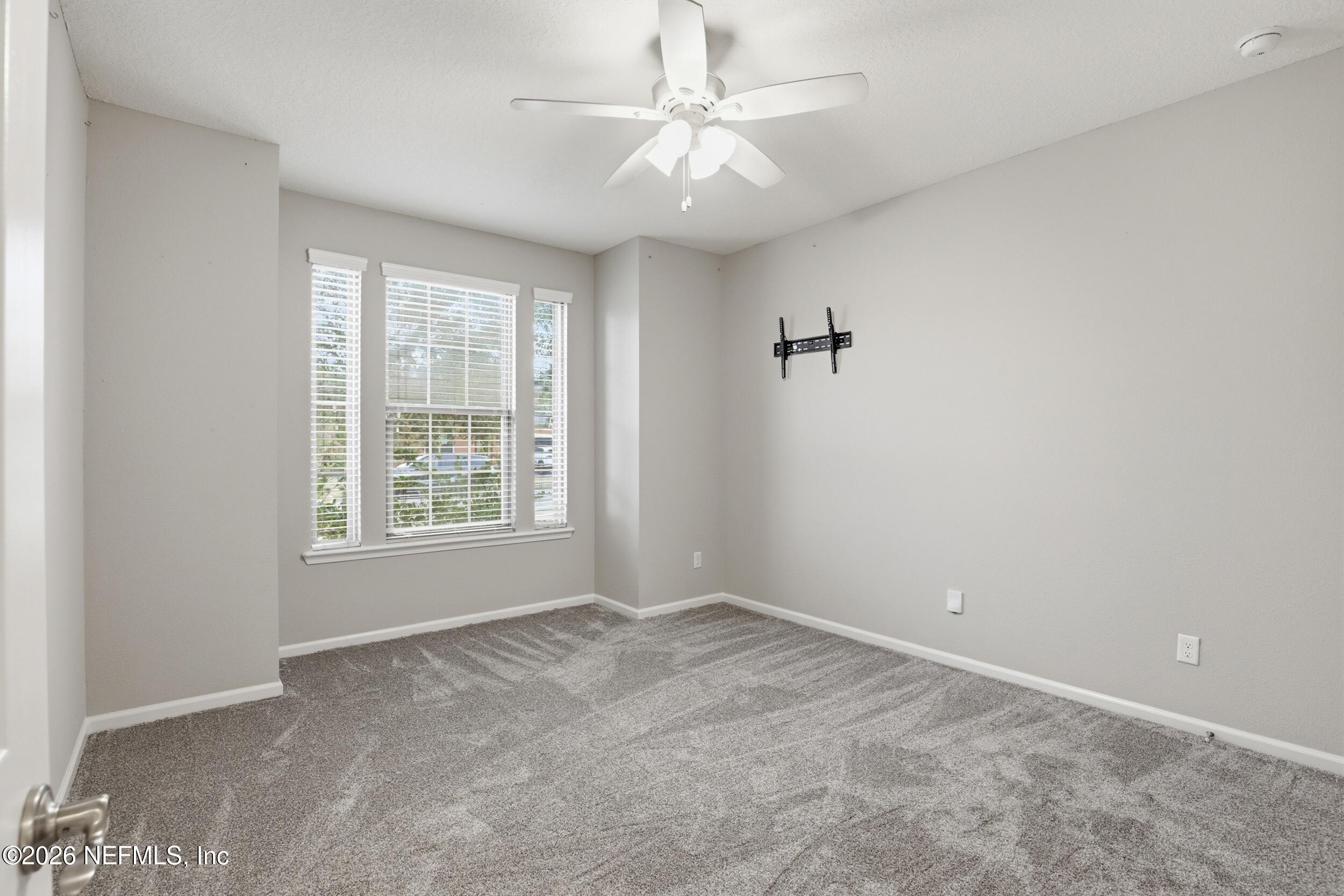 219 Straw Pond Way St. Augustine, FL 32092 - Photo 17 of 36 an empty room with windows and fan