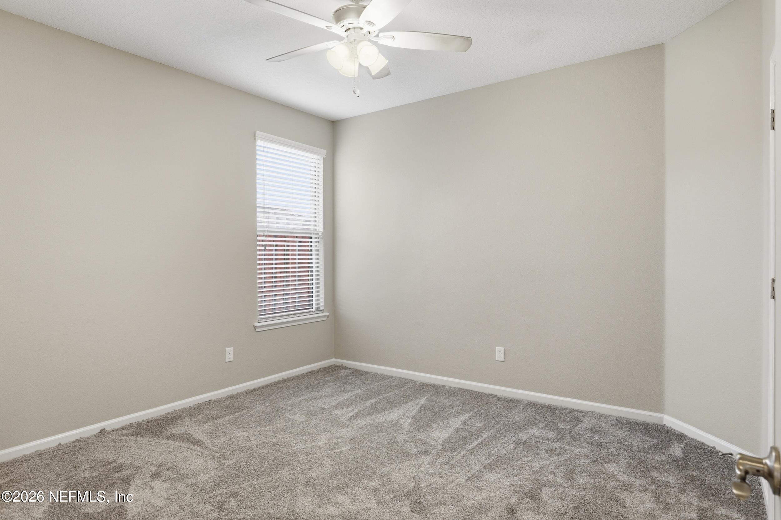 219 Straw Pond Way St. Augustine, FL 32092 - Photo 18 of 36 an empty room with a window and a fan