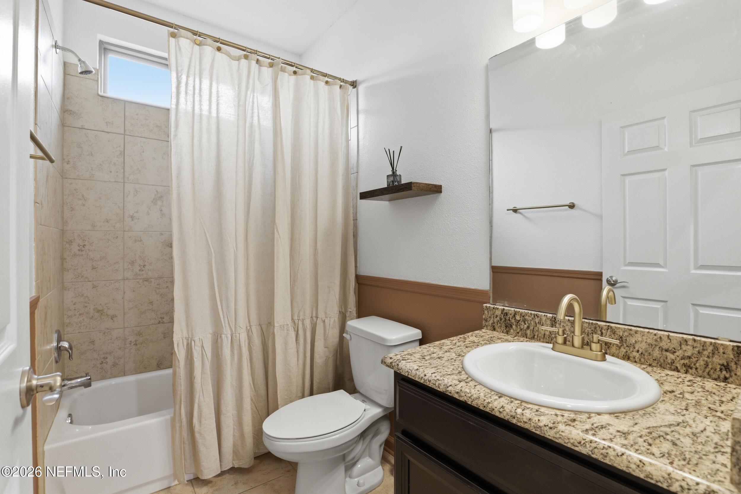 219 Straw Pond Way St. Augustine, FL 32092 - Photo 19 of 36 a bathroom with a granite countertop sink toilet and shower