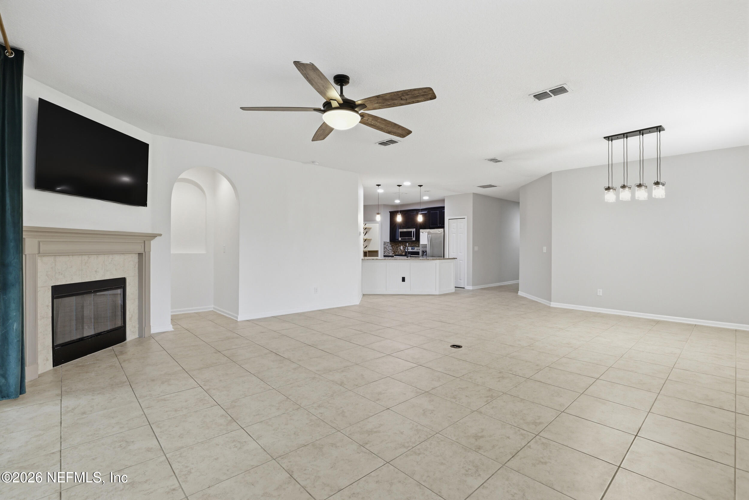 219 Straw Pond Way St. Augustine, FL 32092 - Photo 9 of 36 a view of a livingroom with a fireplace a ceiling fan and window