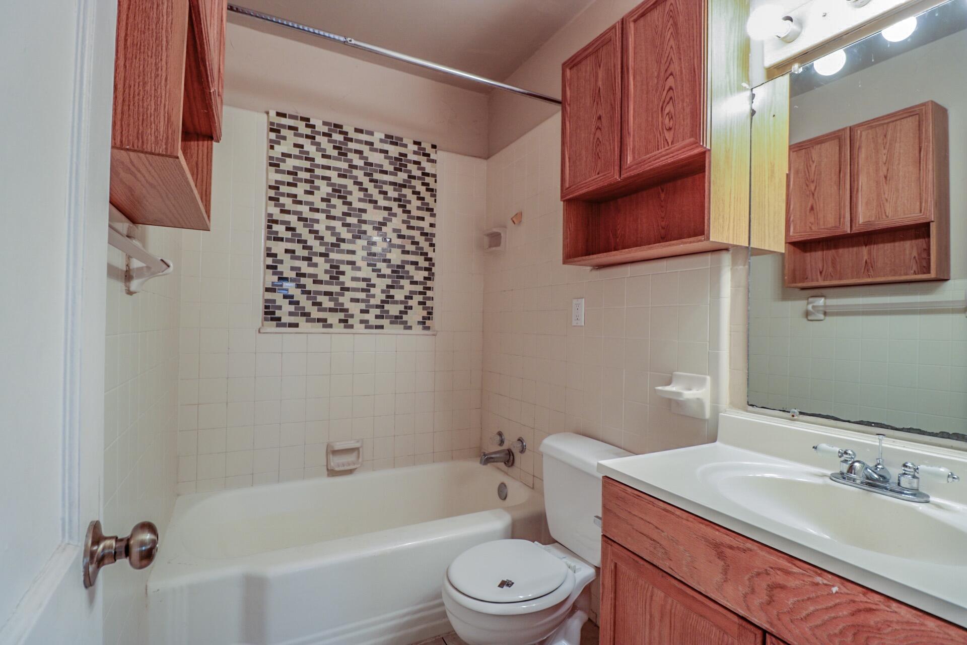 2509 36th Street Lubbock, TX 79413 - Photo 5 of 9 a bathroom with a sink a toilet and shower