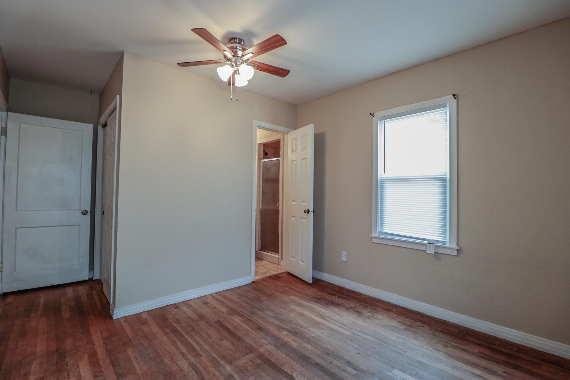 2509 36th Street Lubbock, TX 79413 - Photo 7 of 9 an empty room with wooden floor and window