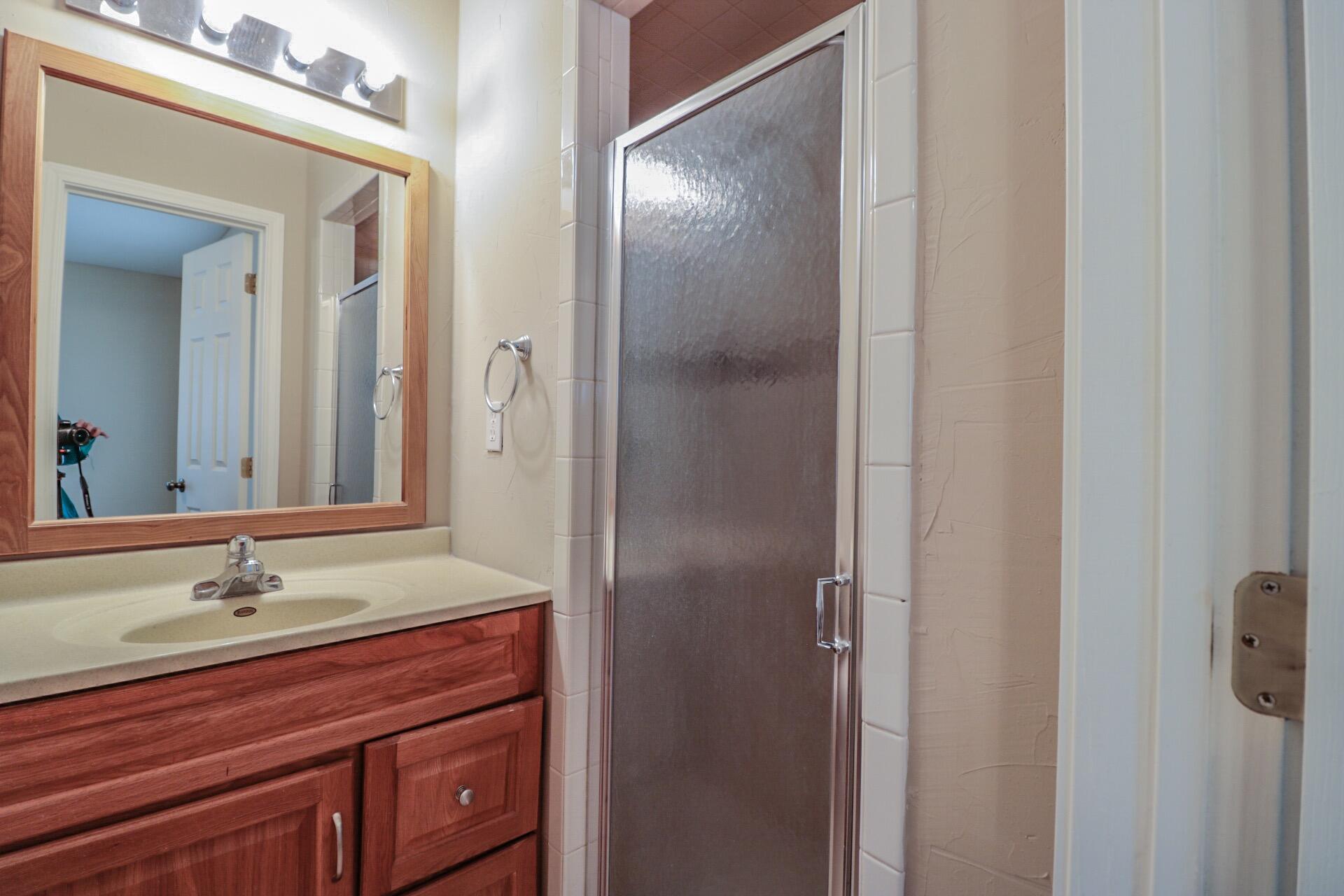 2509 36th Street Lubbock, TX 79413 - Photo 8 of 9 a bathroom with a sink and mirror