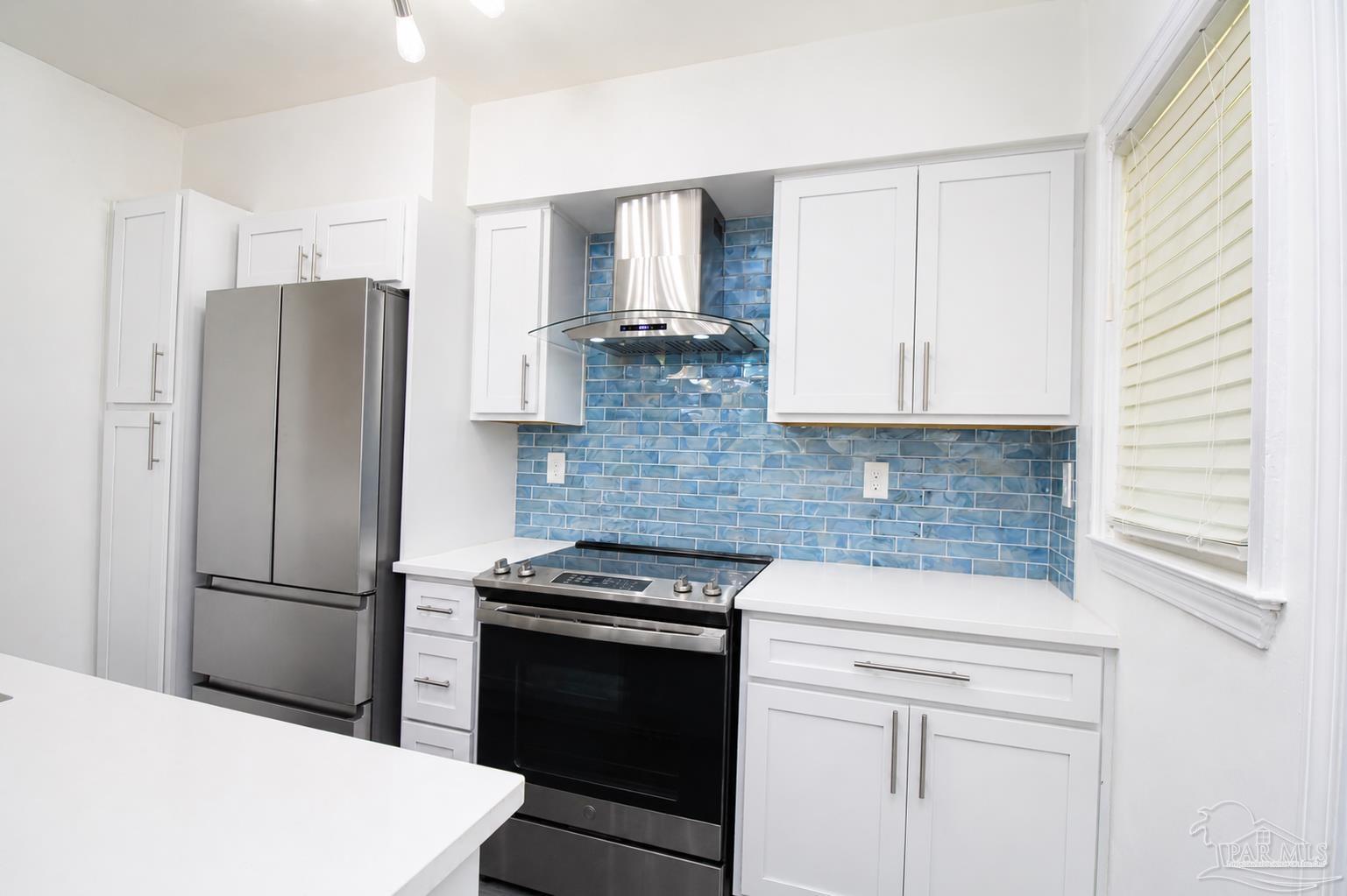 315 Flannan Road Pensacola, FL 32507 - Photo 9 of 17 a kitchen with a refrigerator stove and cabinets