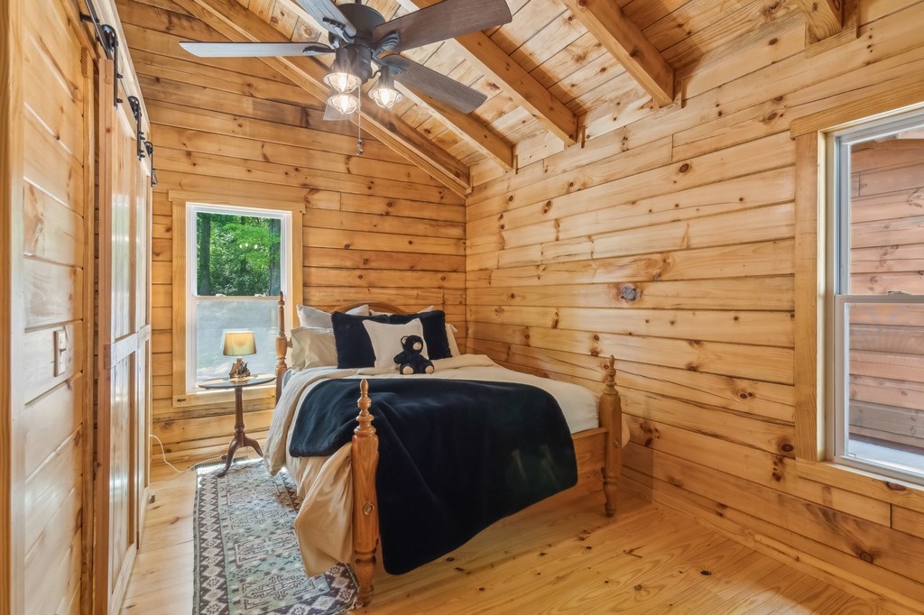 245 Timberwalk Drive Ellijay, GA 30540 - Photo 28 of 56 a bedroom with a bed and a mirror