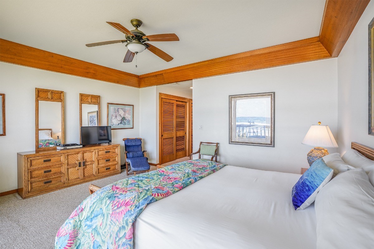 2221 Kapili Road, Unit 58 Koloa, HI 96756 - Photo 13 of 30 a bedroom with a bed and wooden floor