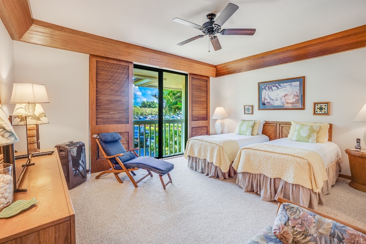 2221 Kapili Road, Unit 58 Koloa, HI 96756 - Photo 17 of 30 a bedroom with a bed a lamp and a large window
