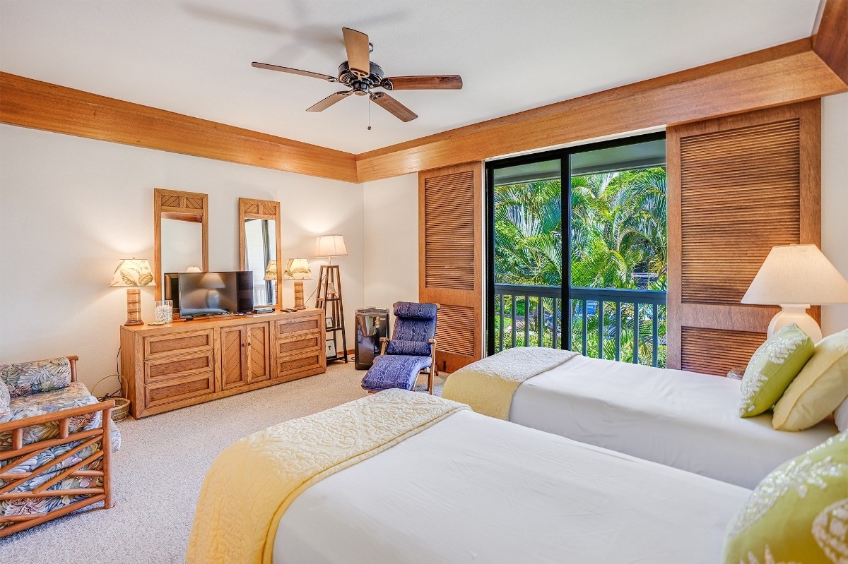 2221 Kapili Road, Unit 58 Koloa, HI 96756 - Photo 18 of 30 a bedroom with a bed a large window and walk in closet