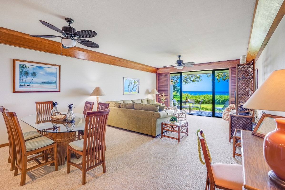 2221 Kapili Road, Unit 58 Koloa, HI 96756 - Photo 4 of 30 a living room with furniture a floor to ceiling window and a flat screen tv