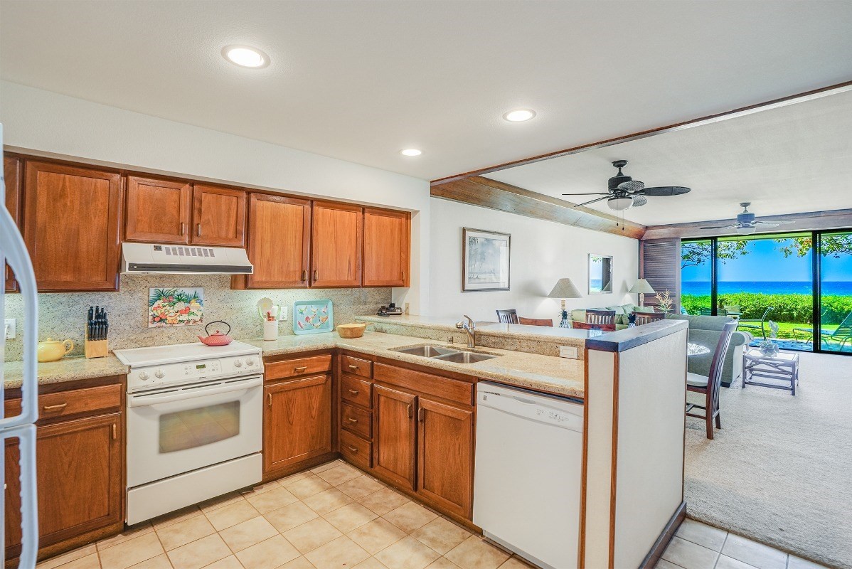 2221 Kapili Road, Unit 58 Koloa, HI 96756 - Photo 9 of 30 a kitchen with a stove sink and cabinets