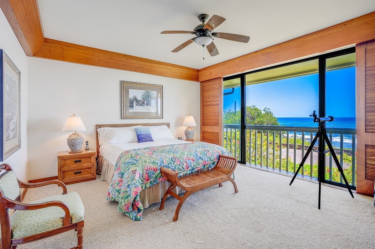 2221 Kapili Road, Unit 58 Koloa, HI 96756 - Photo 10 of 30 a spacious bedroom with a bed and a chandelier