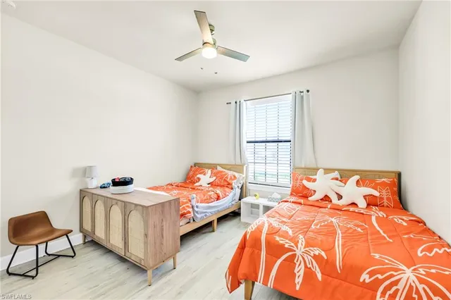 a bedroom with two beds and a window