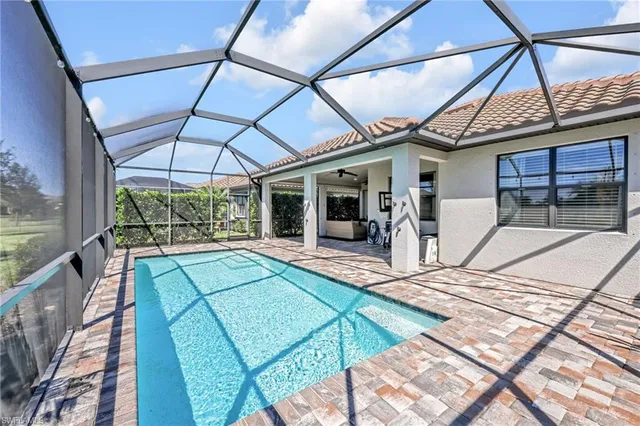 a view of a patio with a table and chairs under an umbrella