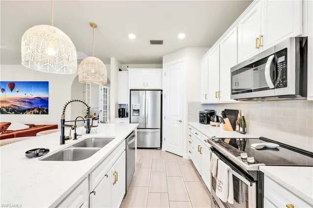 a kitchen with stainless steel appliances granite countertop a sink and cabinets