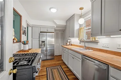 a kitchen with a sink stove and refrigerator