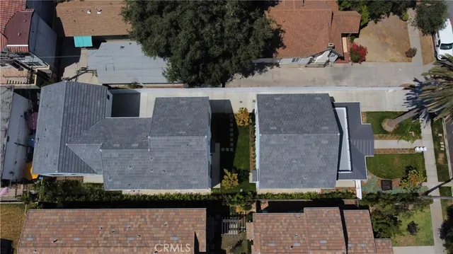 an aerial view of a house with garden space and street view