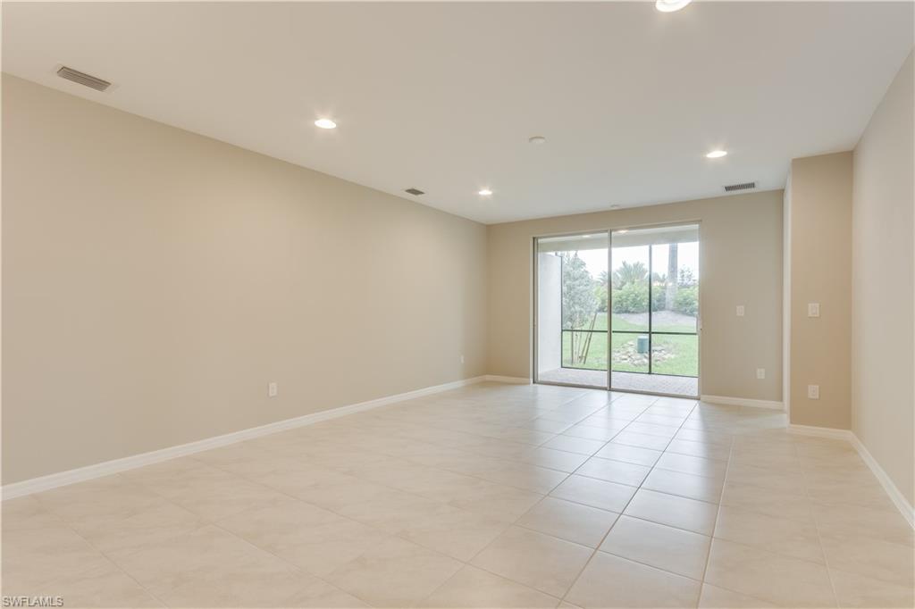 14863 Edgewater Circle Naples, FL 34114 - Photo 18 of 35 a view of an empty room with a sliding door