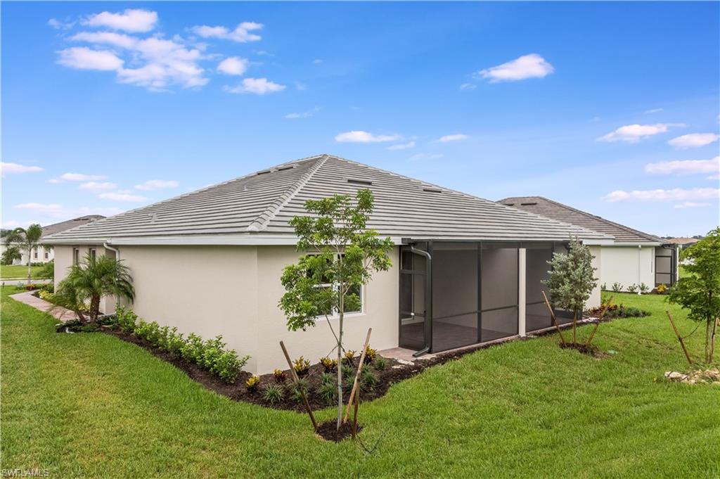 14863 Edgewater Circle Naples, FL 34114 - Photo 20 of 35 a front view of a house with a garden